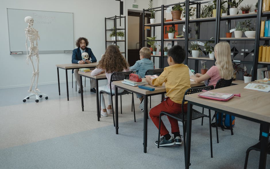 Children in an elementary classroom learning biology with a teacher and skeleton model.